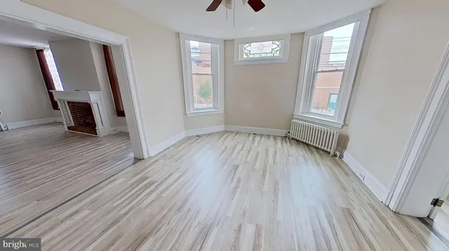 an empty room with windows and closet