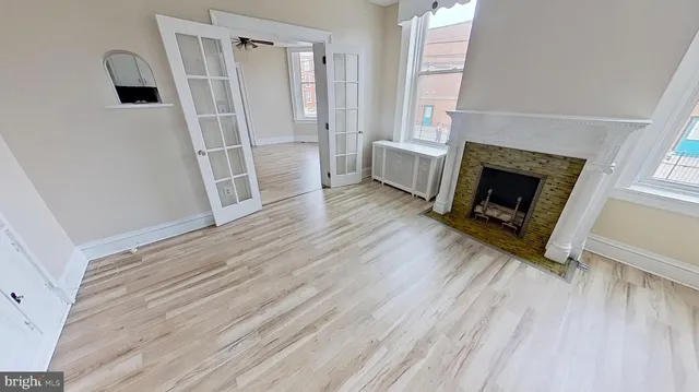 a kitchen with granite countertop a refrigerator stove and white cabinets