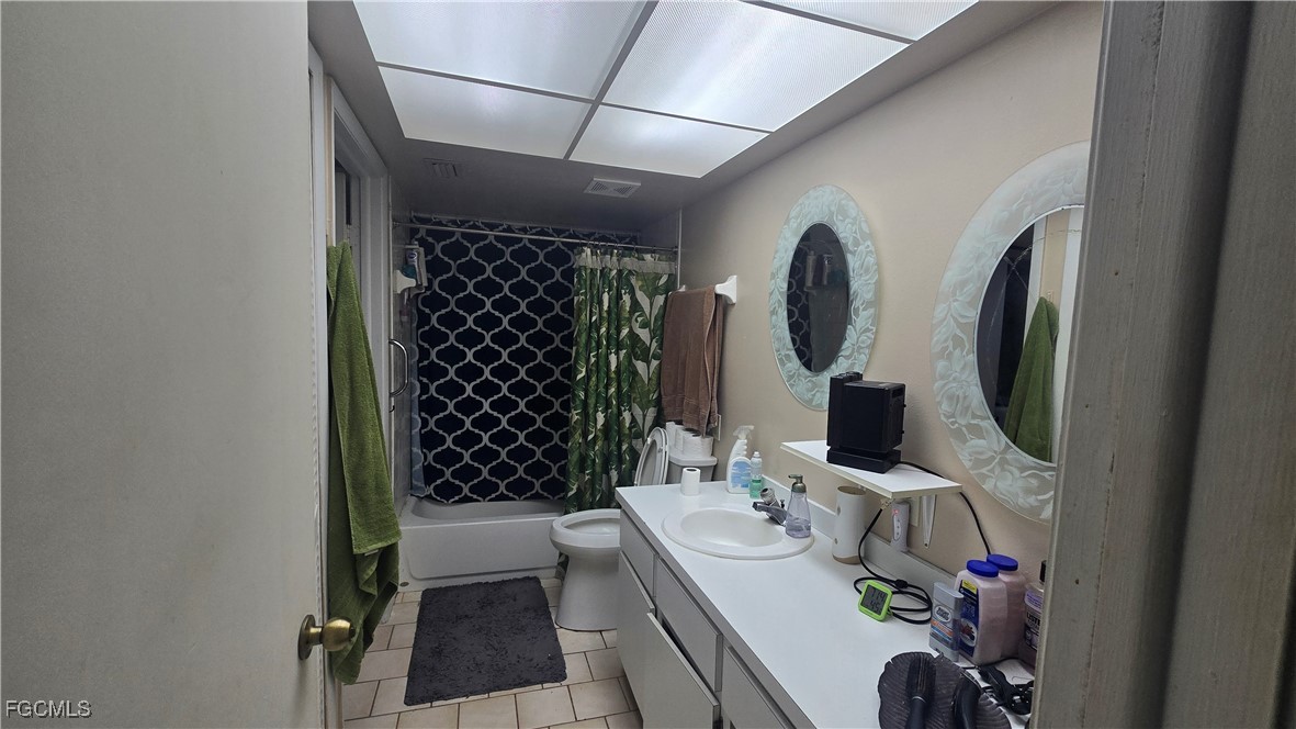 606 Gerald Avenue, Unit 112 Lehigh Acres, FL 33936 - Photo 15 of 17 a bathroom with a sink a toilet and shower