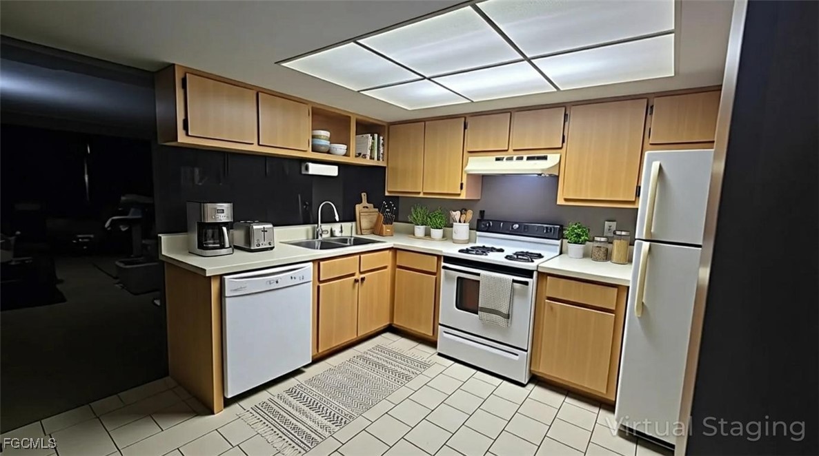 606 Gerald Avenue, Unit 112 Lehigh Acres, FL 33936 - Photo 4 of 17 a kitchen with stainless steel appliances granite countertop a stove and a sink