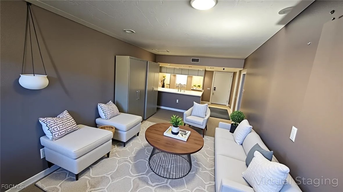 606 Gerald Avenue, Unit 112 Lehigh Acres, FL 33936 - Photo 8 of 17 a living room with furniture and a large window