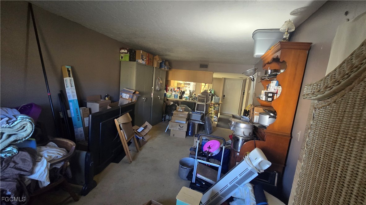 606 Gerald Avenue, Unit 112 Lehigh Acres, FL 33936 - Photo 9 of 17 a living room with furniture and a flat screen tv