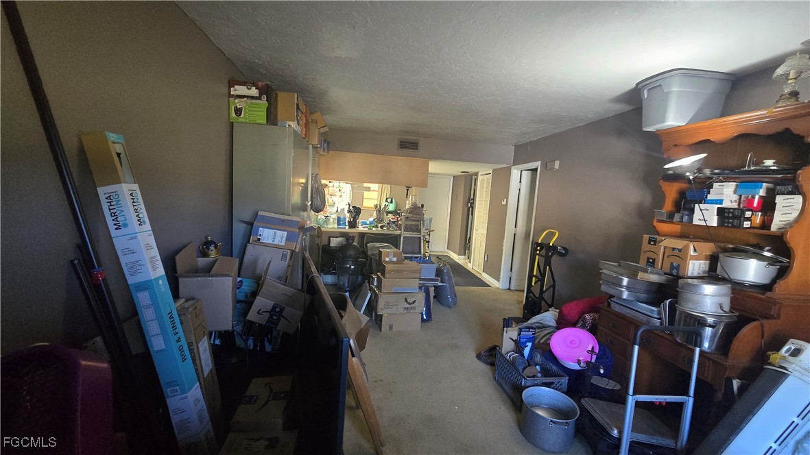 606 Gerald Avenue, Unit 112 Lehigh Acres, FL 33936 - Photo 10 of 17 a view of a dining room with furniture and a chandelier