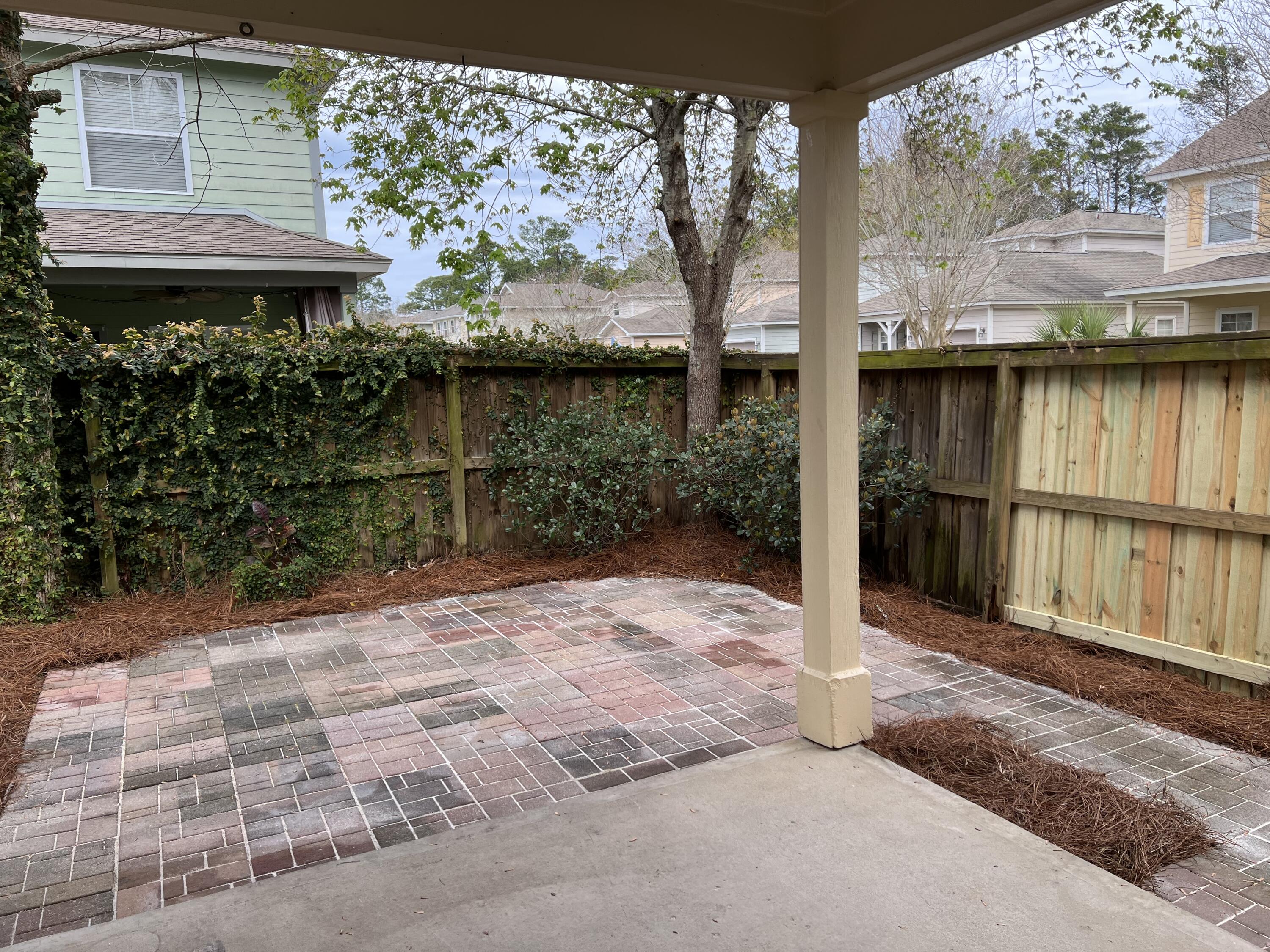 8 Myrtle Oak Way Santa Rosa Beach, FL 32459 - Photo 23 of 29 a view of backyard with large trees and wooden fence