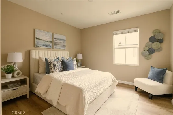 a bedroom with a bed a mirror and wall painting