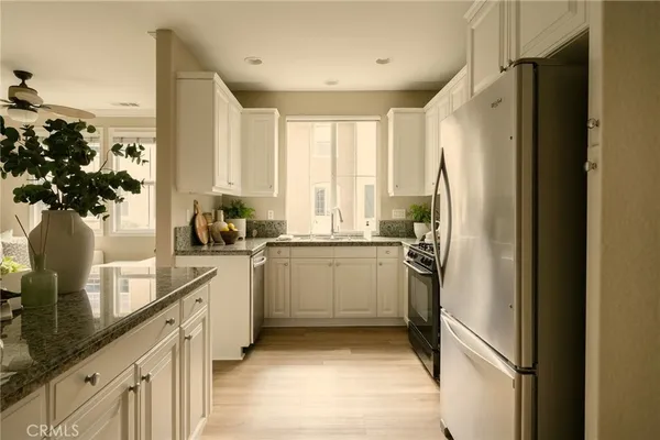 a kitchen with a refrigerator and a sink