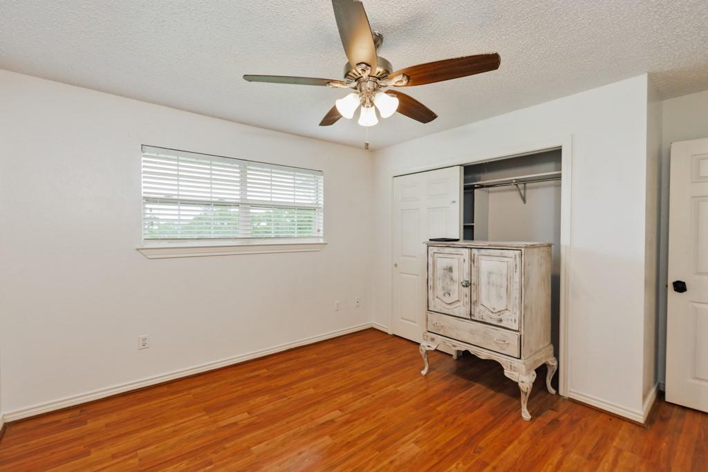 4316 Leona Road Bowie, TX 76230 - Photo 21 of 37 a view of an empty room with wooden floor and a window