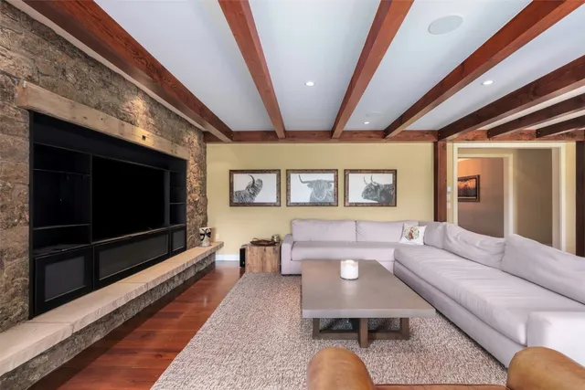 a kitchen with granite countertop a stove and a wooden floors
