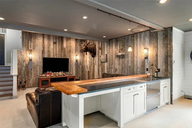 a living room with furniture a rug and a large window