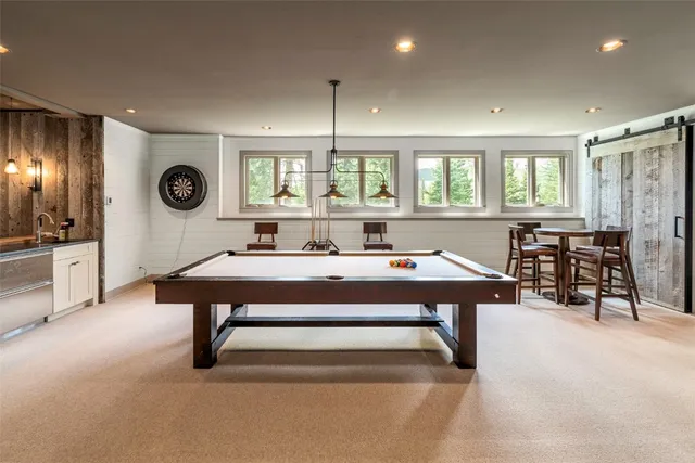 a living room with furniture a flat screen tv and a large window