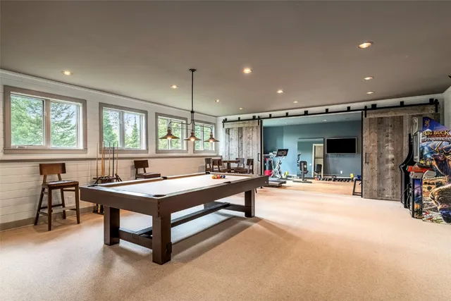 a living room with gym equipment and a flat screen tv