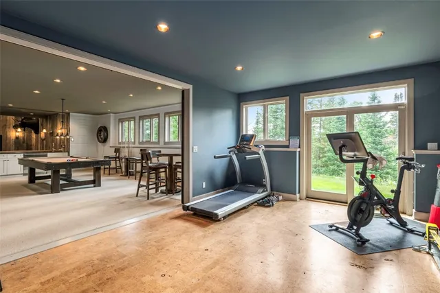 a spacious bedroom with a bed and a flat screen tv