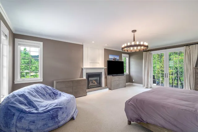a spacious bedroom with a bed and a chandelier