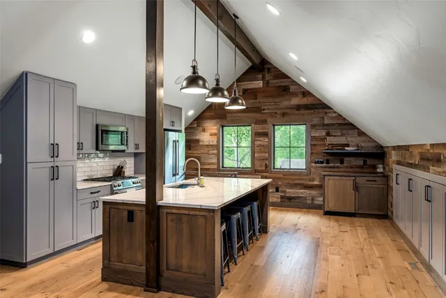 a living room with furniture a flat screen tv and a floor to ceiling window