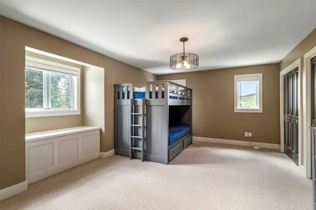 a view of an empty room with window and cabinet