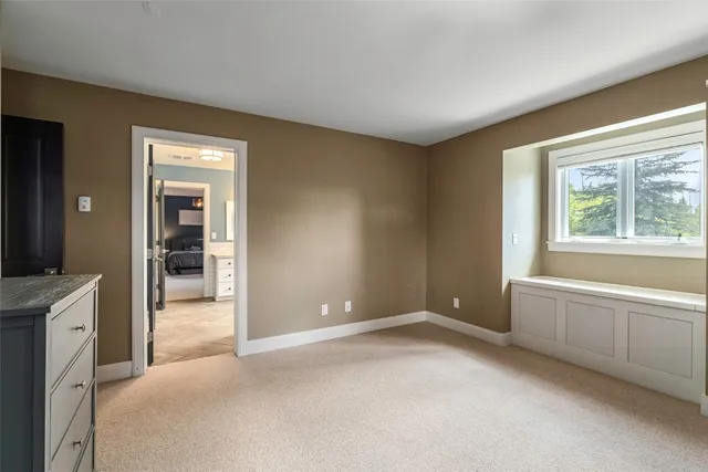 a bathroom with double vanity sink a two mirror a window and a bathtub