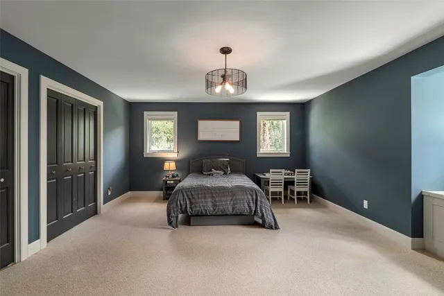 a view of a bedroom with furniture window and a bathroom
