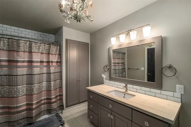 a bathroom with a sink a toilet and shower curtain