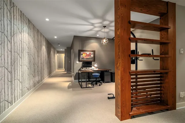 a spacious bedroom with a bed and a tv