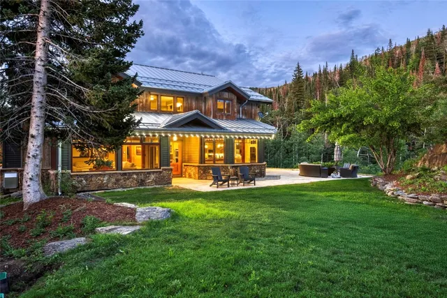 a view of a house with a big yard and garden
