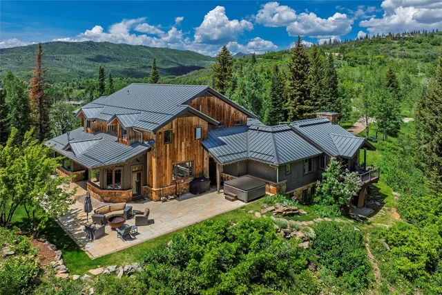 an aerial view of a house with swimming pool patio and outdoor seating