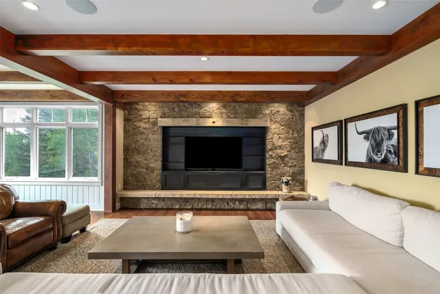 a living room with a couch a rug and a flat screen tv