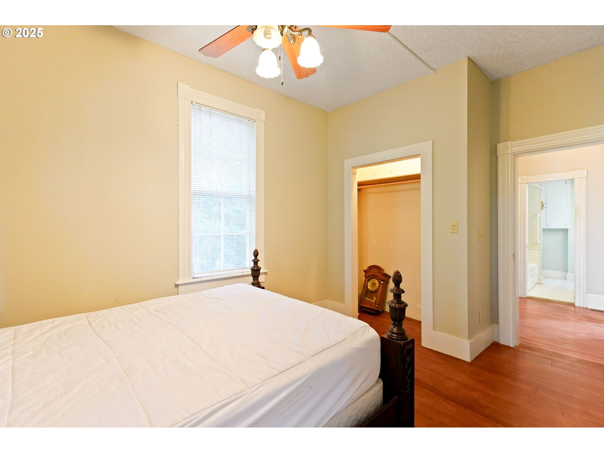 10478 Crosby Road Northeast Woodburn, OR 97071 - Photo 18 of 43 a bedroom with a bed and wooden floor