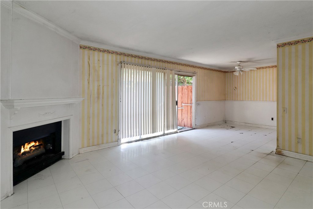 7554 Corbin Avenue, Unit 1 Reseda, CA 91335 - Photo 6 of 10 a view of an empty room with a fireplace and a window