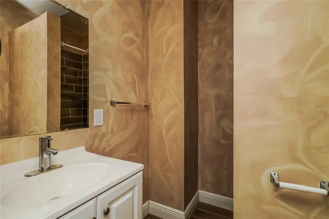 a bathroom with a sink and a mirror