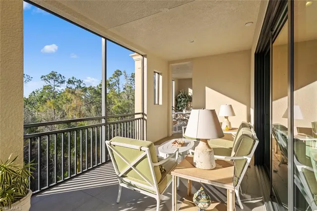 a view of a living room with a floor to ceiling window and potted plant
