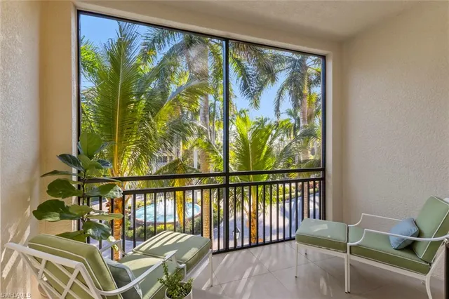 a living room with furniture and a floor to ceiling window