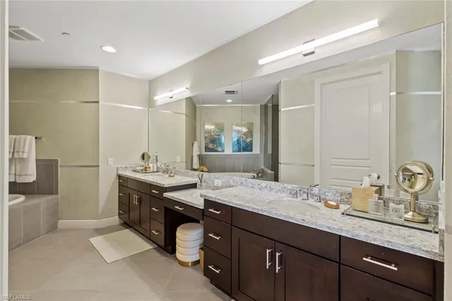 a bedroom with a bed and a lamp next to a large window