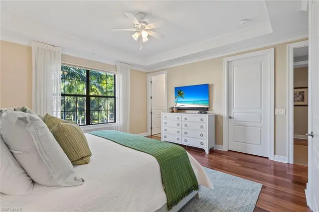 a bedroom with a large bed and a chandelier