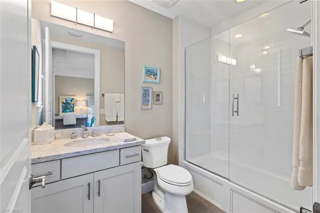 a spacious bedroom with a bed and a chandelier