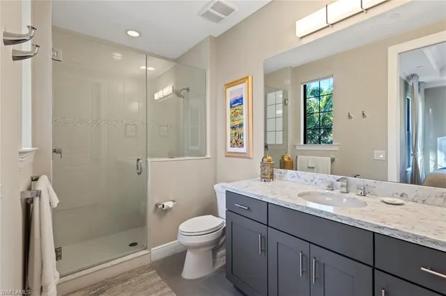 a bedroom with two beds and large window