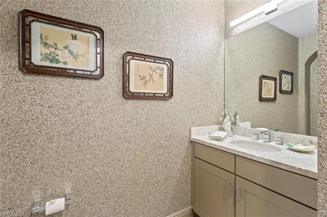 a view of a kitchen with white cabinets