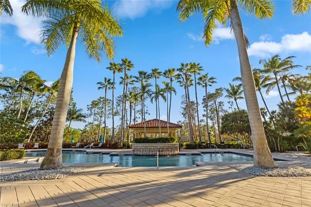 a view of yard with swimming pool and seating area