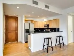 a view of kitchen with stainless steel appliances granite countertop a stove a sink and a refrigerator