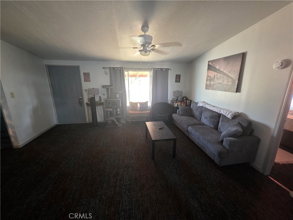 10623 Desert View Road Pinon Hills, CA 92372 - Photo 42 of 76 a living room with furniture and a chandelier