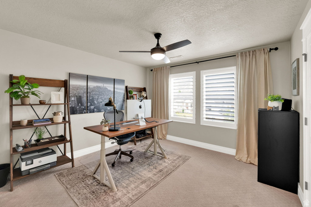 1132 South 1300th Street West Mapleton, UT 84664 - Photo 24 of 52 Neutral-toned room with carpet flooring featuring two windows with white louvered shutters and a ceiling fan with integrated lighting