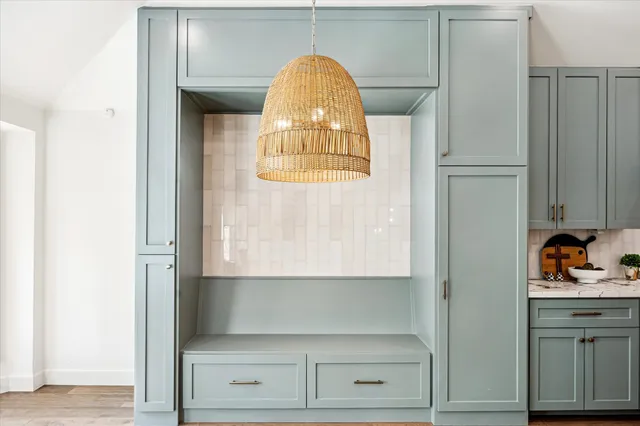 a living room with furniture a fireplace and a potted plant