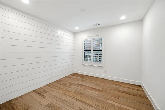 a view of a table and chairs in patio with wooden fence