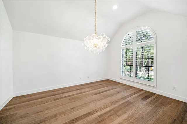 a view of a room with wooden floor and chandelier