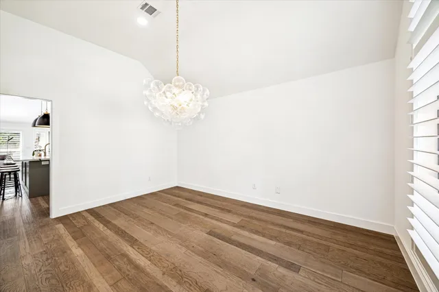 a view of a room with wooden floor