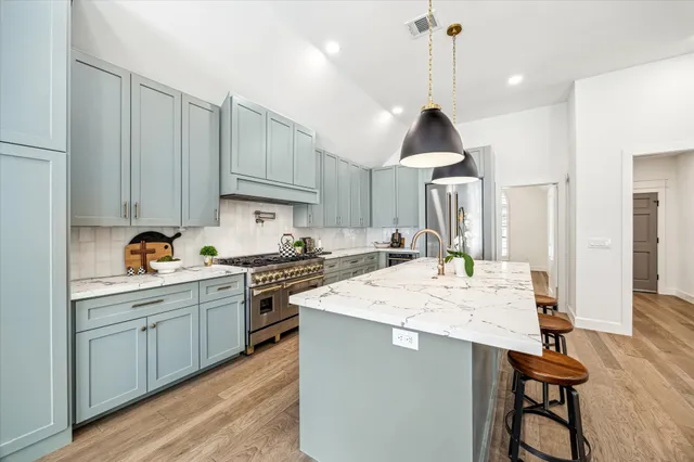 a view of a hallway with wooden floors and cabinet