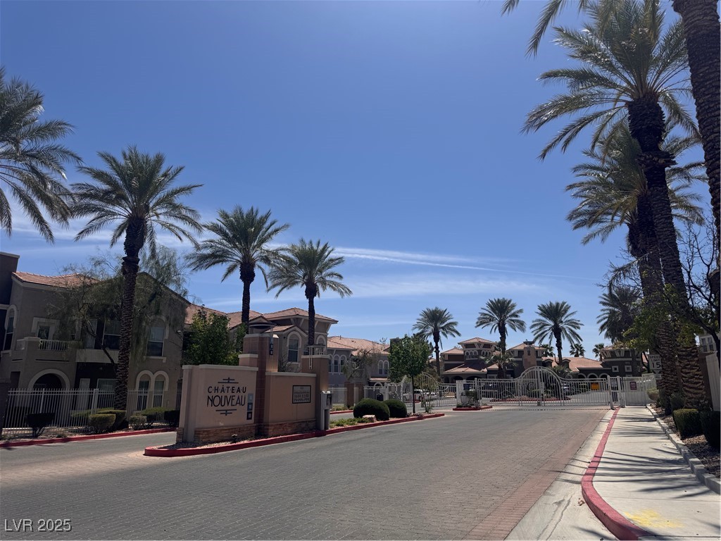 9975 Peace Way, Unit 1140 Las Vegas, NV 89147 - Photo 17 of 23 View of street with a gate, sidewalks, a gated entry, curbs, and a residential view