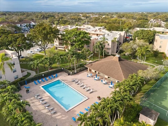 a view of a swimming pool with outdoor seating