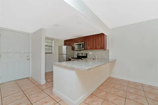 a kitchen with cabinets and a stove top oven