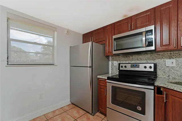 a kitchen with a stove microwave and refrigerator