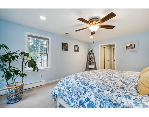67 Wildwood Road Stow, MA 01775 - Photo 15 of 30 a bedroom with a bed and a chandelier